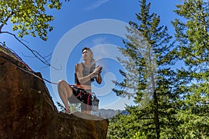 A Fit Mixed Race Female Athlete Rock Climbs In The Pacific Northwest