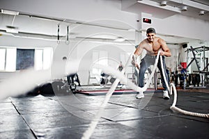 Fit and muscular arabian man posing in gym.