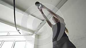 Fit muscular woman exercising with a kettlebell