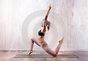 Fit muscular young woman doing a low lunge