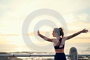 Fit is not a destination, its a way of life. a young sporty woman running outside.