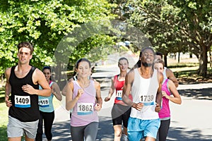 Fit people running race in park