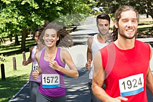 Fit people running race in park