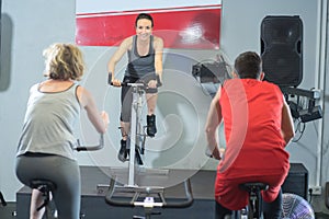 Fit people in spin class at gym