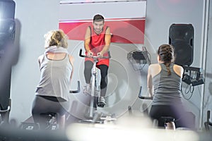 Fit people in spin class at gym