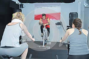 Fit people in spin class at gym