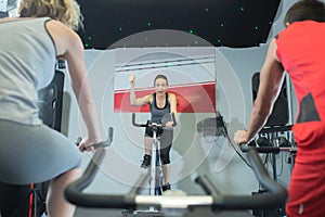 Fit people in spin class at gym