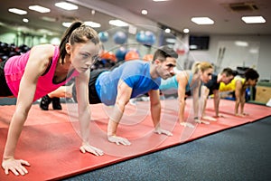 Fit people working out in fitness class