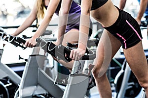 Fit people working out at spinning class