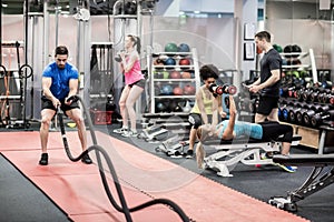 Fit people working out in weights room