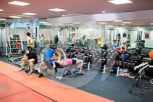 Fit people working out in weights room