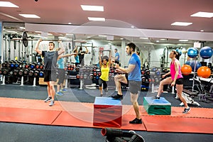 Fit people working out in weights room