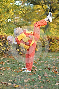 Fit senior couple exercising in autumn park