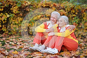 Fit senior couple exercising in autumn park