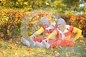 Fit senior couple exercising in autumn park