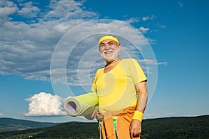 Fit senior man resting after working out. Active sport workout for old person. Funny sporty old sportsman finished his