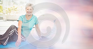 Fit senior woman exercising in yoga class