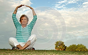 Fit senior woman meditation/praise