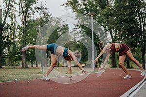 Fit sisters performing impressive flips and cartwheels in a park. Inspiring active lifestyle and showcasing, strength
