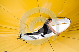 Fit slim woman warming up and exercising near Riga river Daugava at sunset - Shot of urban city wellness concept -