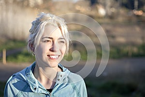 Fit smiling blonde looking at camera