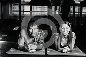 Fit sportive man and woman doing plank core exercise training back and press muscles concept gym sport sportsman fitness