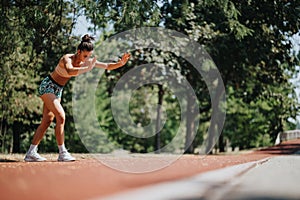 Fit sports person performs cartwheels in the park, showcasing athleticism, motivation, and active lifestyle.