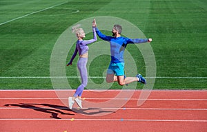 fit sporty people feel success. man and woman sport trainer. fitness couple training outdoor. gesture of sport shake