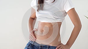 Fit sporty woman with abs and c-section scar. Postpartum recovery