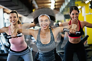 Fit sporty women exercising and training at fitness club