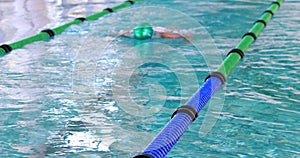 Fit swimmer doing the breast stroke in the swimming pool