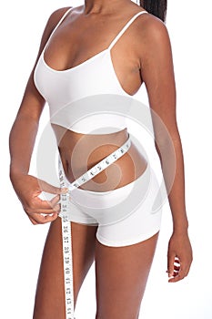 Fit torso of black woman checking diet weight loss