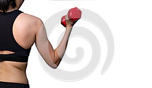 Fit woman arm exercise with red dumbbell in gym. Female weight training by personal trainer. Woman workout for strength and strong