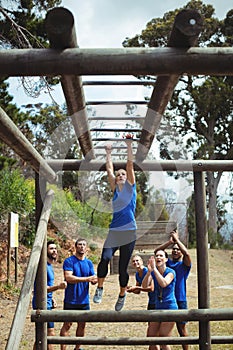 Fit woman climbing monkey bars