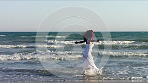 Fit woman dancing on beach
