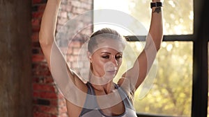 Fit woman doing arm exercise with weight on workout at gym or studio. Portrait of fitness girl model in active wear