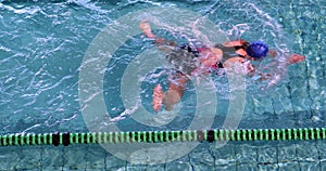 Fit woman doing the breast stroke in swimming pool