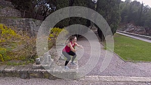 Fit woman doing cardio exercises in the park