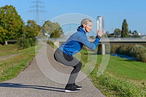 Fit woman doing crouch stretches to warm up