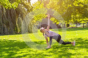 Fit woman doing lunge and stretch exercises