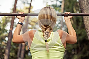 Fit woman doing pull-ups