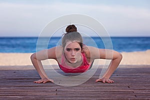 Fit woman doing push up or press up