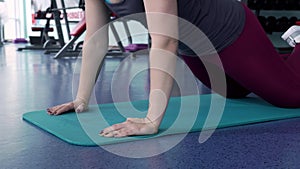 Fit Woman Doing Push Ups Exercise at the Gym