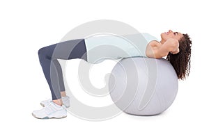 Fit woman doing sit ups on exercise ball