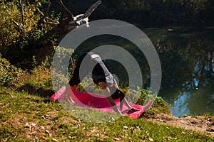 Fit woman doing yoga practice in the forest