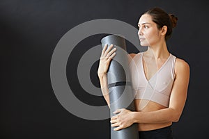 Fit woman with exercise mat