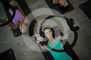 Fit woman exercising with pilates ring