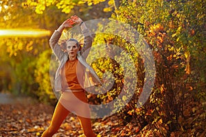 fit woman in fitness clothes in park workout