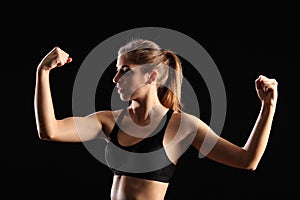 Fit woman flexing muscles during exercise workout