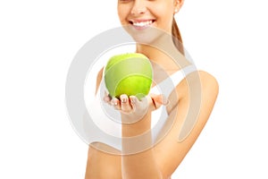 Fit woman giving green apple